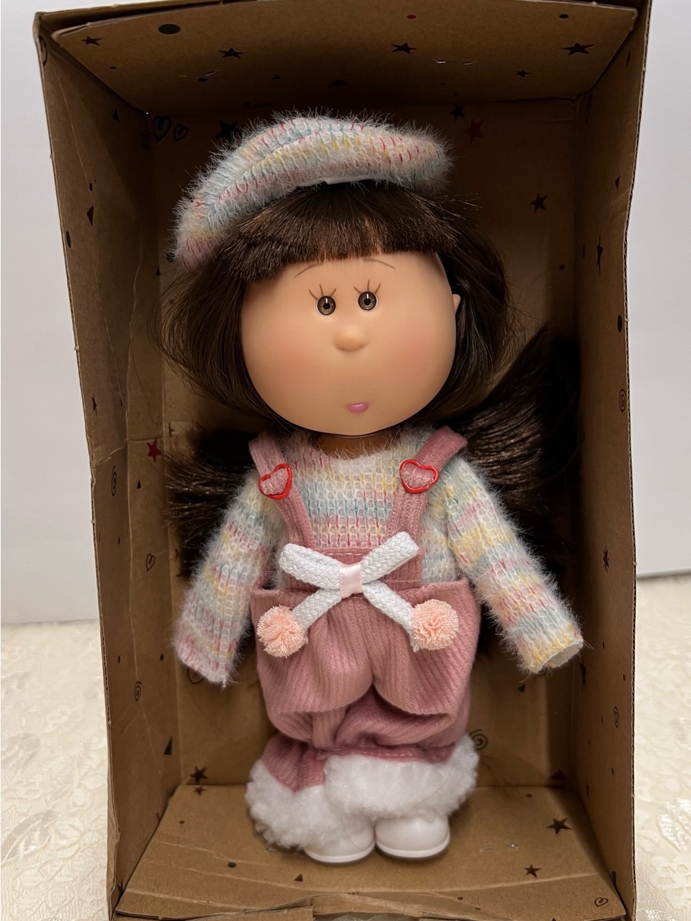 New, Mia Doll with Brown Hair Wearing a Pastel Sweater and Pink Overalls.
